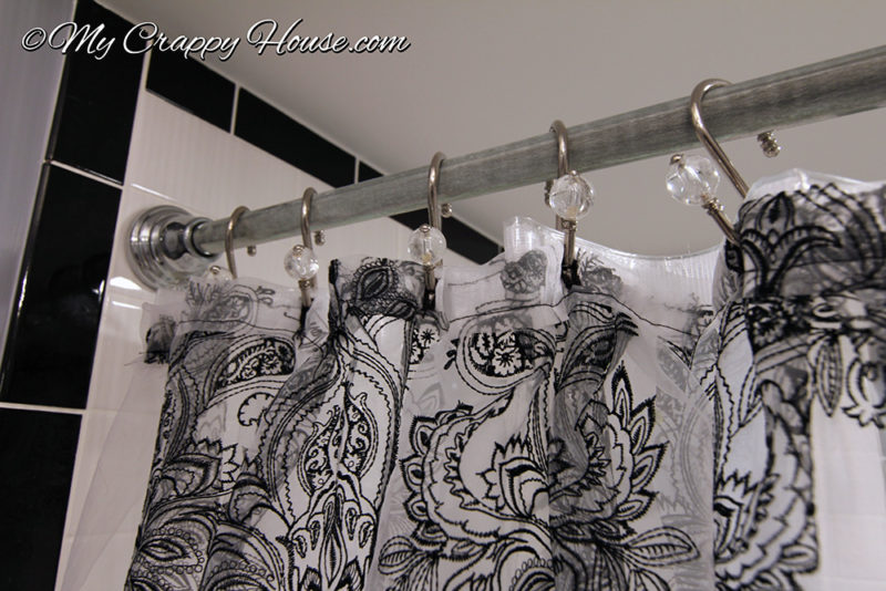 Shower curtain rod with hooks, close up