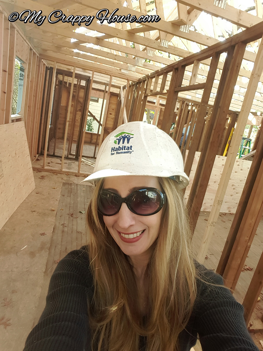 Woman on Habitat for Humanity house site wearing hard hat