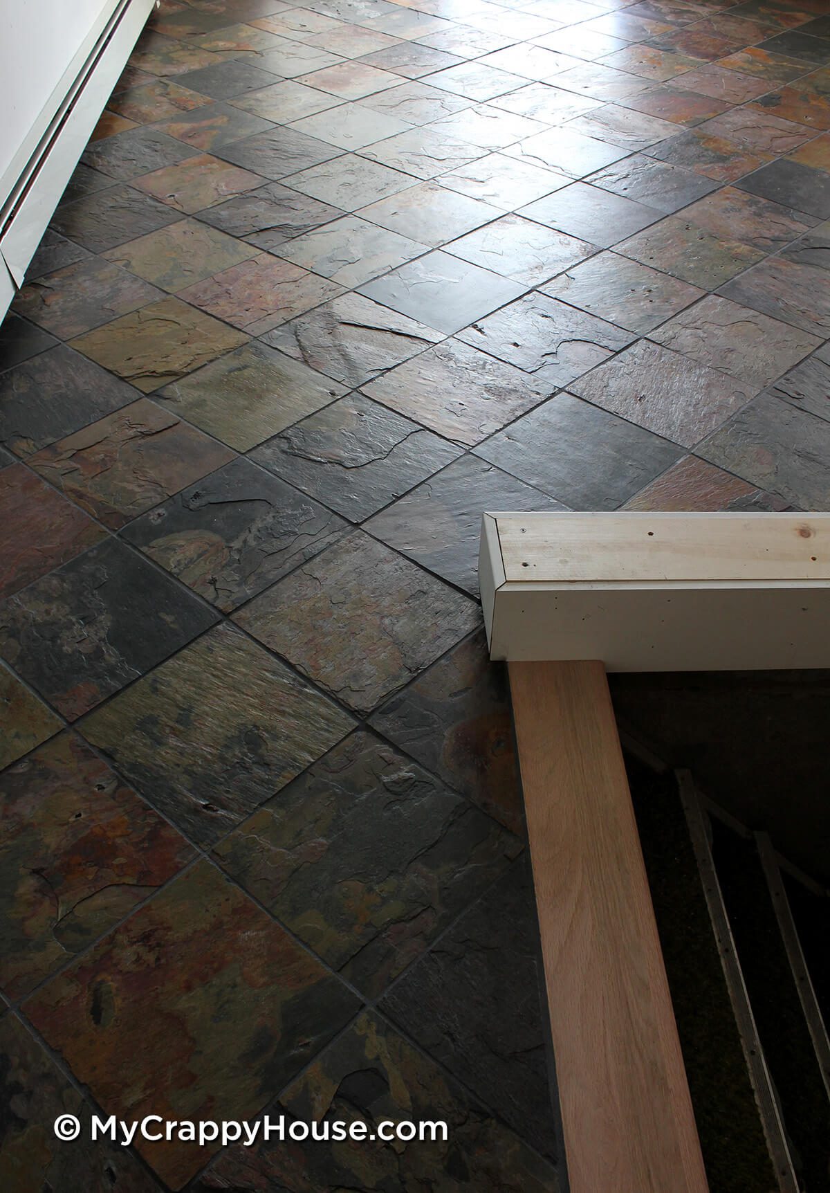 Dining room with finished slate tile floor installed
