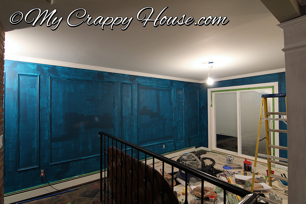one coat of peacock blue paint with poor coverage on dining room wall