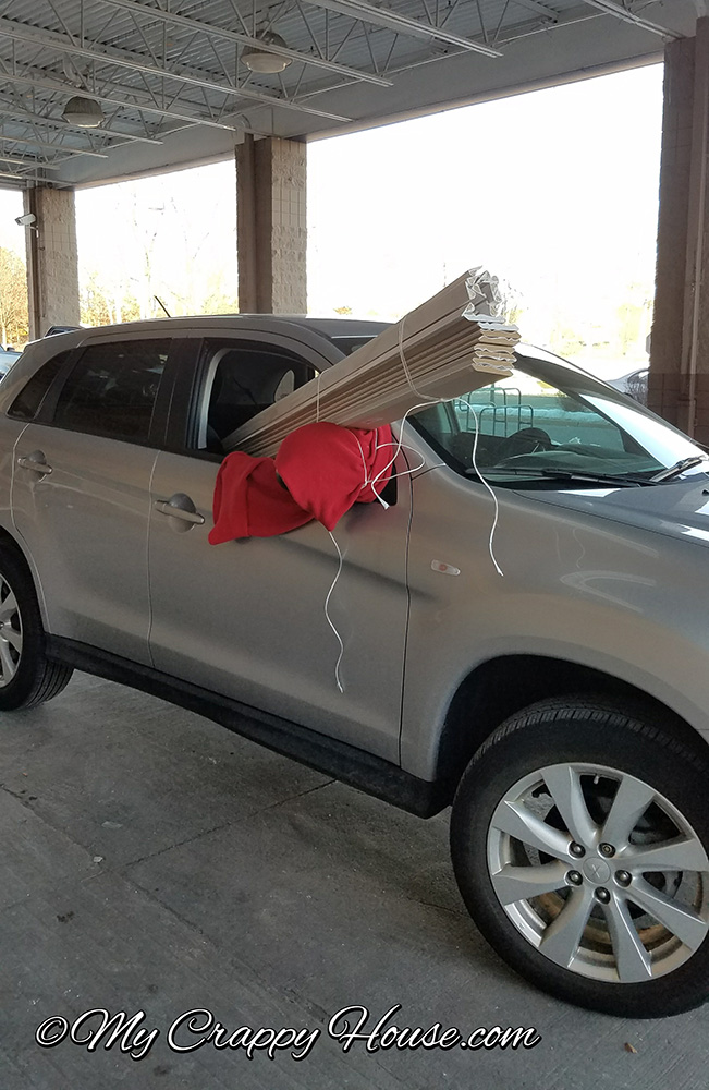 long crown molding loaded into car and poking out of window