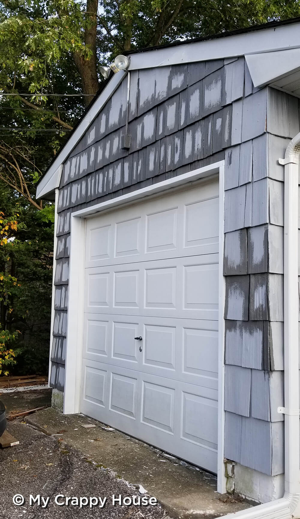 Garage with dark gray paint cut in around cedar shingles