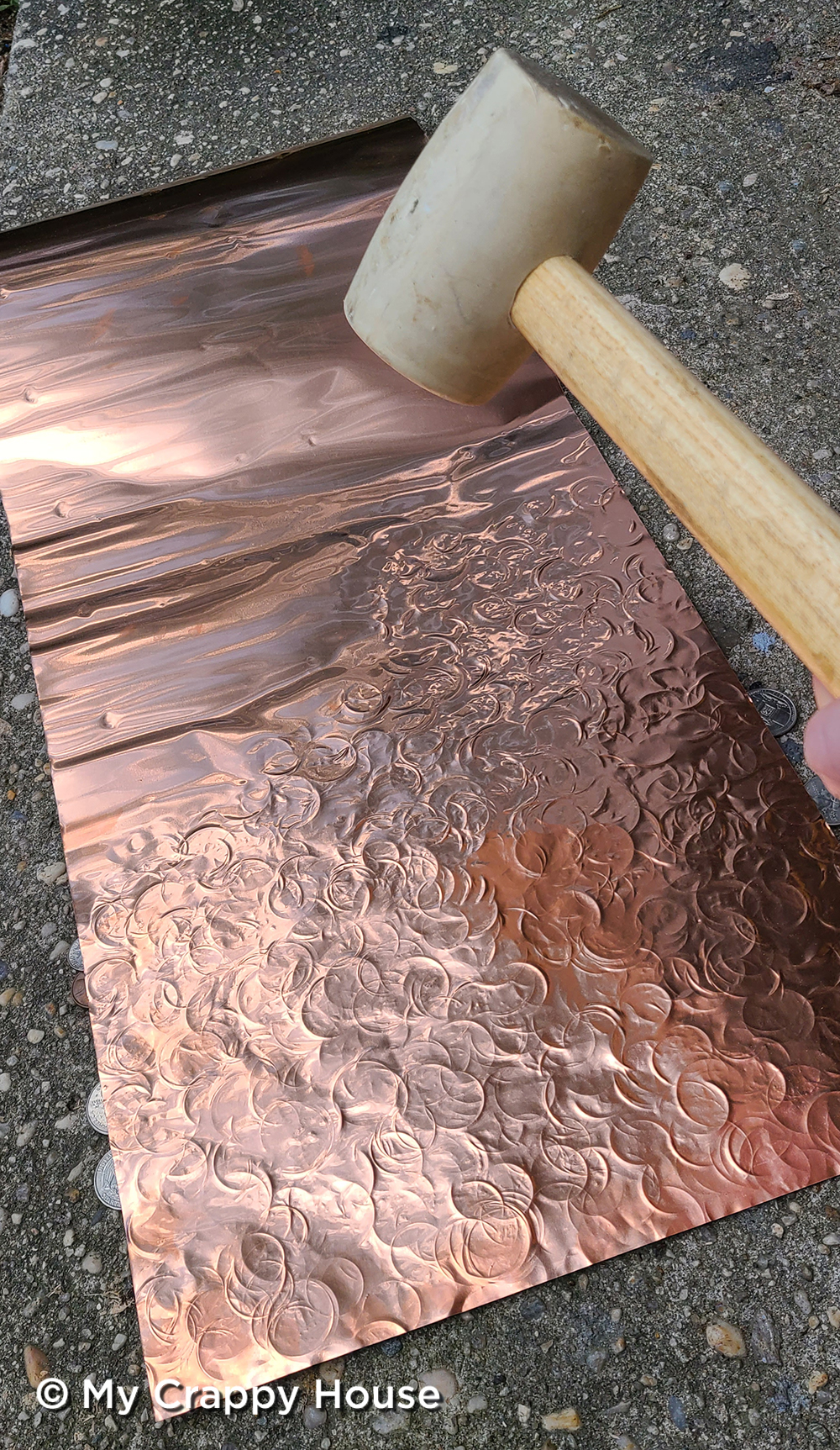 Hammering a texture into copper with a rubber mallet