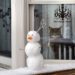 Snowman with scissors in head cat looking on
