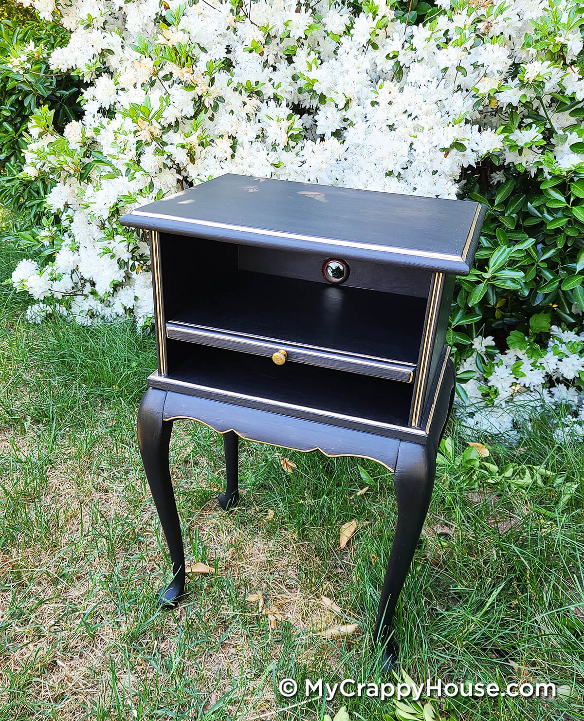 little black side table with gold accents