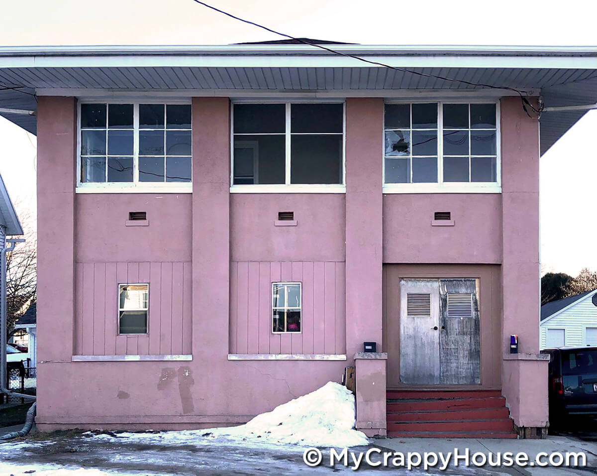 Unusual pink house front without curb appeal