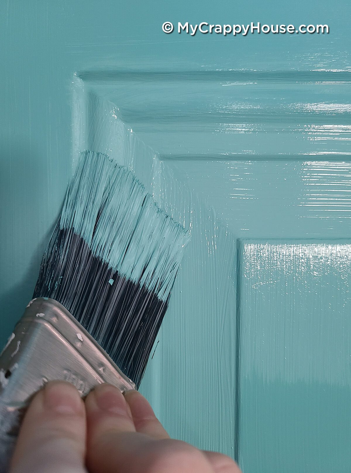 Close up of mitered corners in panel recess on painted door