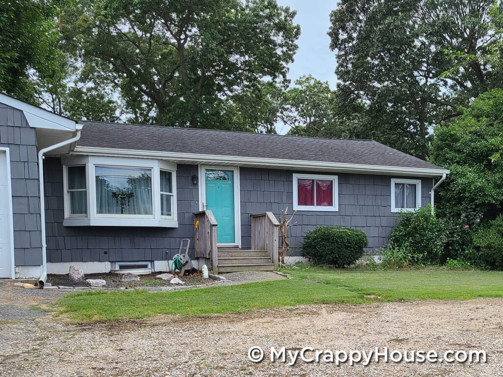 Front door painted aqua sky on a kendall charcoal painted gray house