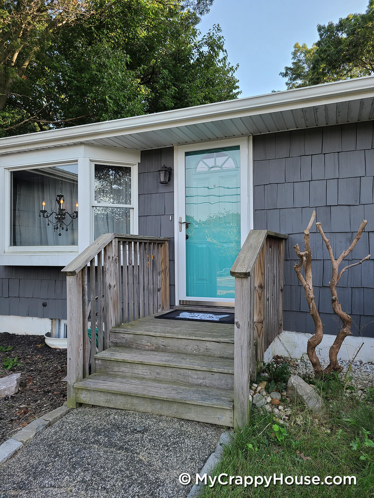 Front door painted aqua sky on a kendall charcoal painted gray house