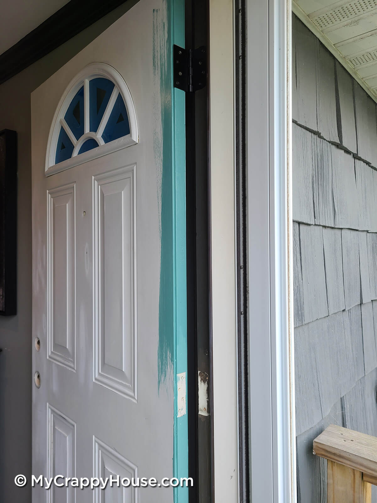 Frond door in the process of being painted. The door edge is aqua sky.