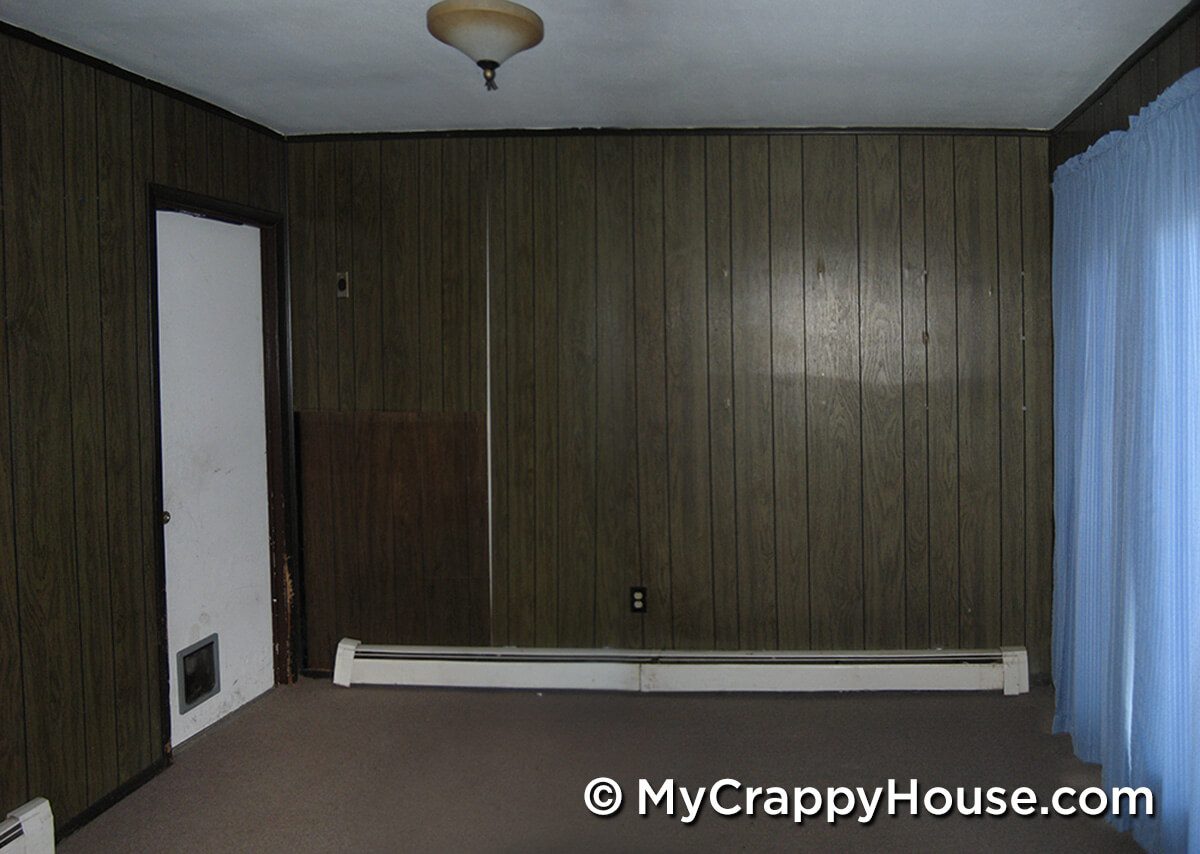 Dining room with 70s brown paneling and no furniture