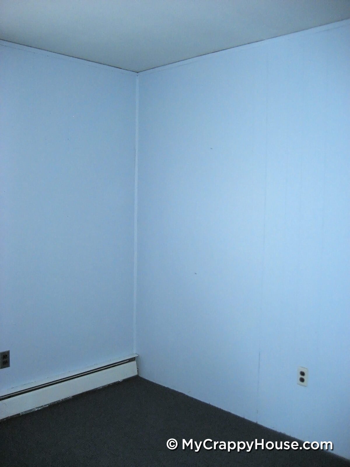 Empty blue bedroom corner