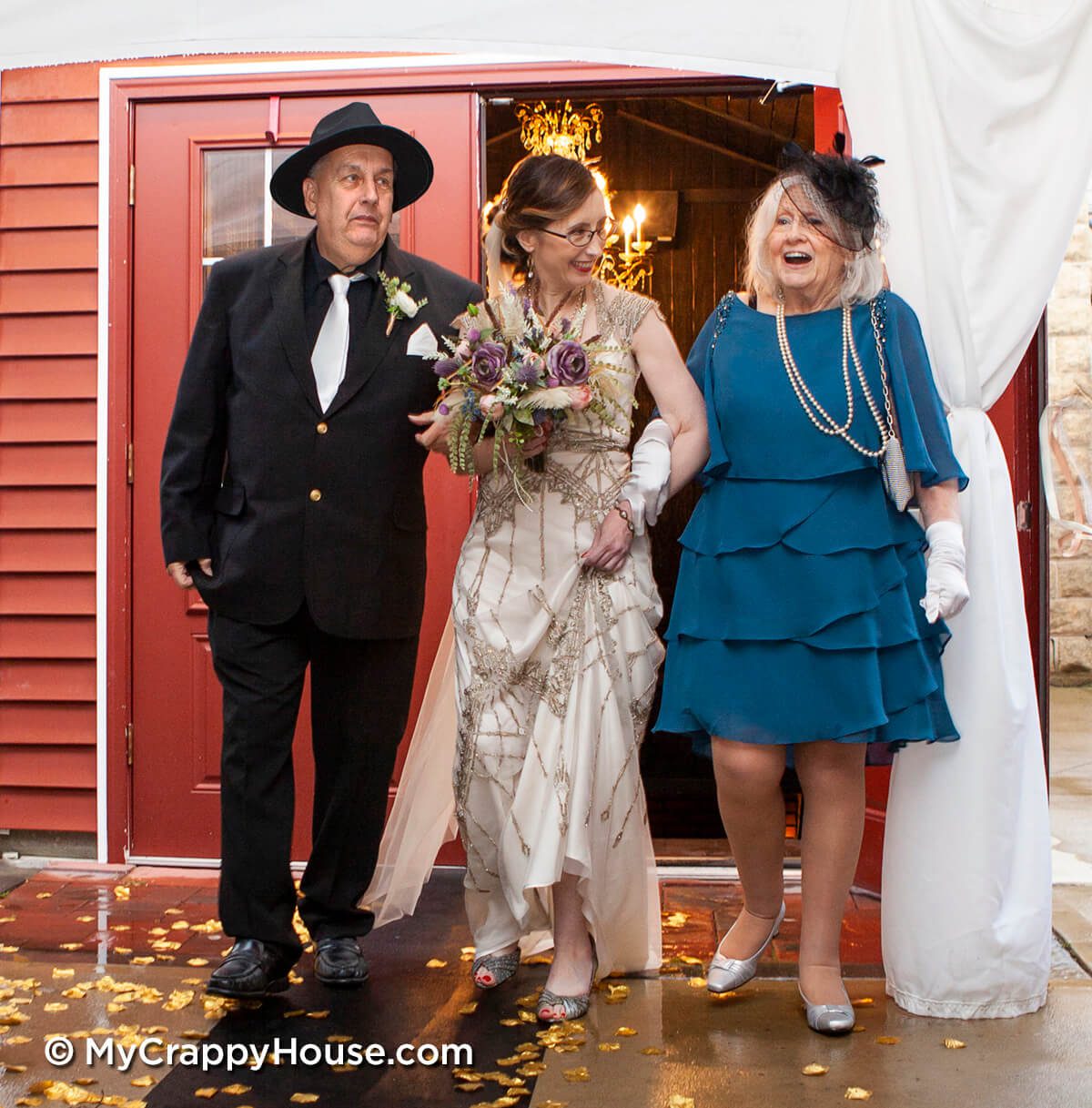 1920s theme bride walking down aisle with parents