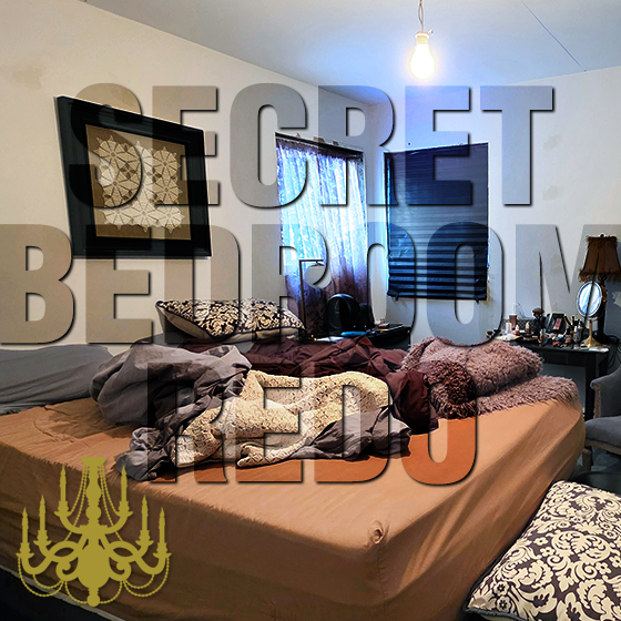 Messy bedroom with spackle on walls, no molding, bare bulb hanging from the ceiling, unmade bed